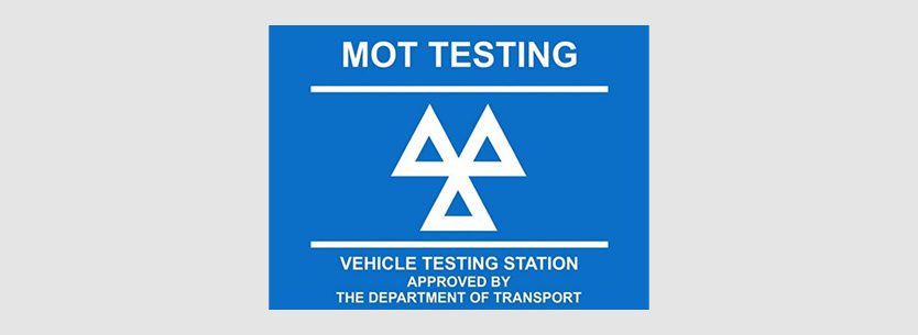 MOT testing sign with white text on a blue background